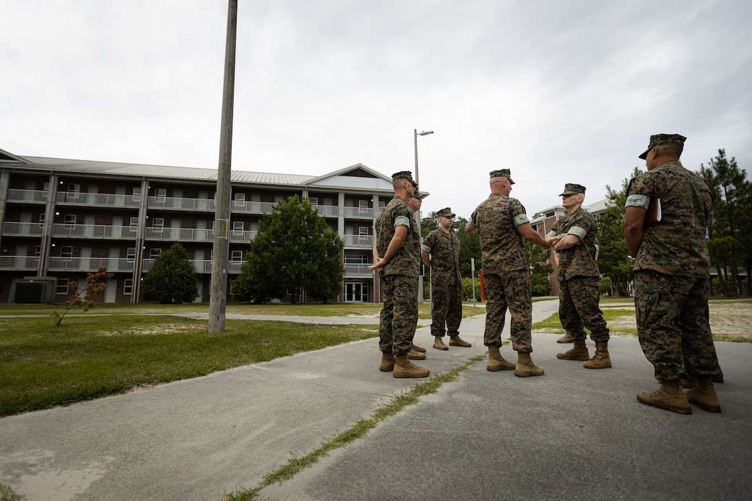 U.S. Marine Corps Gen. Christopher J. Mahoney, center right, the assistant commandant of the Marine Corps (ACMC), speaks to Marine Corps Installations East-Marine Corps Base (MCB) Camp Lejeune and 2nd Marine Logistics Group (MLG) leaders outside of barracks building FC504 during a visit to MCB Camp Lejeune, North Carolina, May 14, 2024. The ACMC visited MCB Camp Lejeune to view current barracks living conditions and observe 2nd MLG and II Marine Expeditionary Force’s capabilities. (U.S. Marine Corps photo by Cpl. Antonino Mazzamuto)