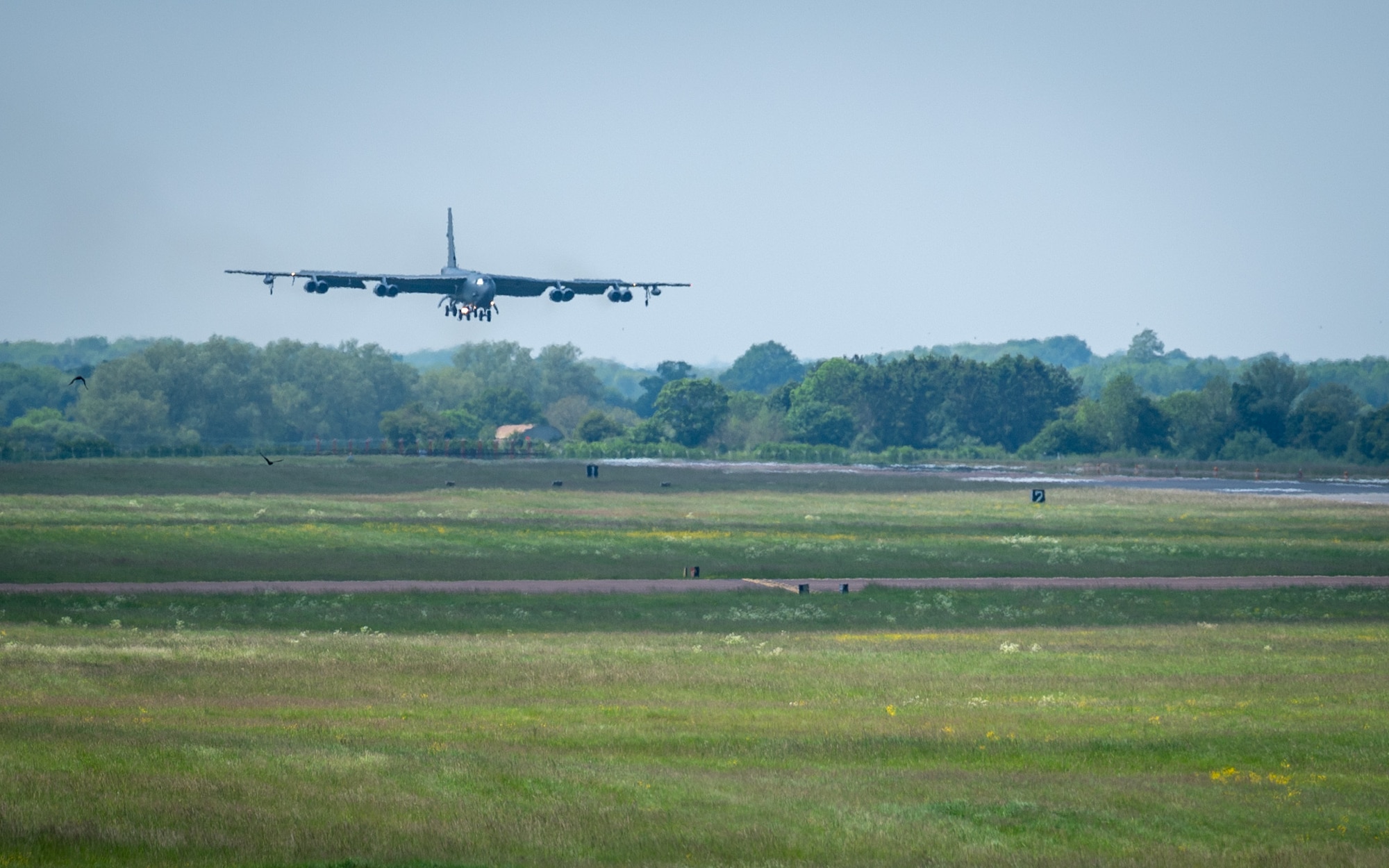 Bomber aircraft lands on runway.