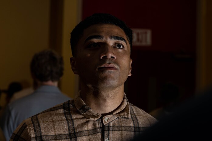 U.S. Marine Corps Recruit Steven Anderson with Mike Company, 3rd Recruit Training Battalion, awaits instruction during a receiving event at Marine Corps Recruit Depot San Diego, California, May 13, 2024. During the receiving process, recruits are searched for contraband, given a haircut, allowed a phone call home, and issued gear. (U.S. Marine Corps photo by Cpl. Sarah M. Grawcock)