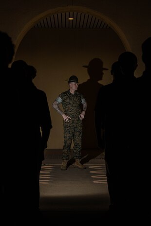 U.S. Marine Corps 1st Sgt. Christopher M. Thomas, a company First Sergeant with Support Battalion, Recruit Training Regiment, observes the receiving process for Mike Company at Marine Corps Recruit Depot San Diego, California, May 13, 2024. During the receiving process, recruits are searched for contraband, given a haircut, allowed a phone call home, and issued gear. (U.S. Marine Corps photo by Cpl. Sarah M. Grawcock)