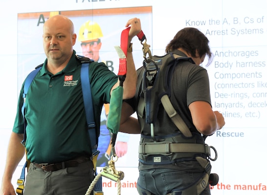 A man in fall protection equipment.