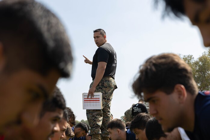 U.S. Marine Corps Staff Sgt. Alan Nieves, a canvassing recruiter with Recruiting Sub-Station Orange, Recruiting Station Orange County, prepares poolees for a portion of an initial strength test during a pool function in Fountain Valley, Calif., May 11, 2024. Pool functions are held to prepare poolees for the mental and physical rigors of recruit training. (U.S. Marine Corps photo by Cpl. Fred Garcia)