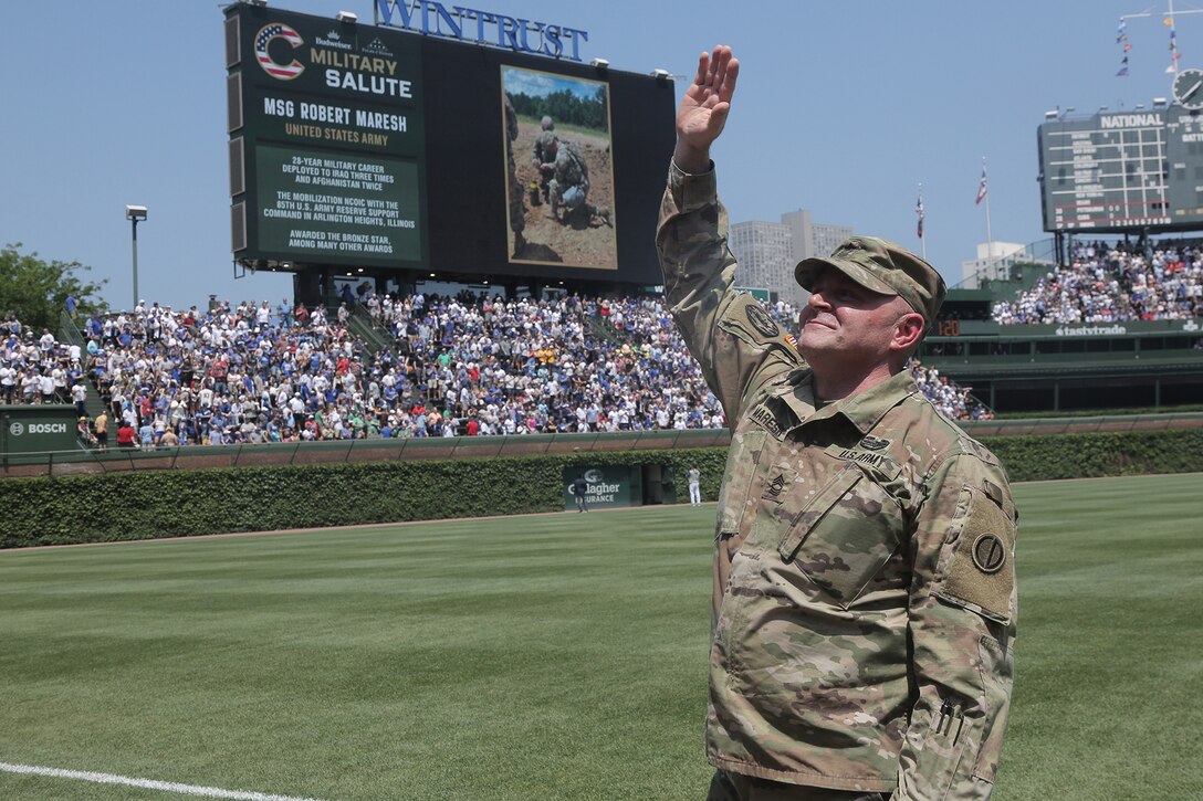 U.S. Army Reserve Master Sgt. Robert Maresh, G-3 Mobilization cell, 85th U.S. Army Reserve Support Command, waves to a crowd of cheering baseball fans during the Chicago Cubs military salute, May 17, 2024, at Wrigley Field.