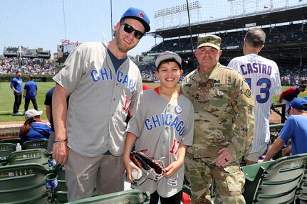 Baseball fans joined U.S. Army Reserve Master Sgt. Robert Maresh, right, G-3 mobilization cell, 85th U.S. Army Reserve Support Command, at Wrigley Field before the start of the Chicago Cubs versus Pittsburg Pirates game, May 17, 2024.