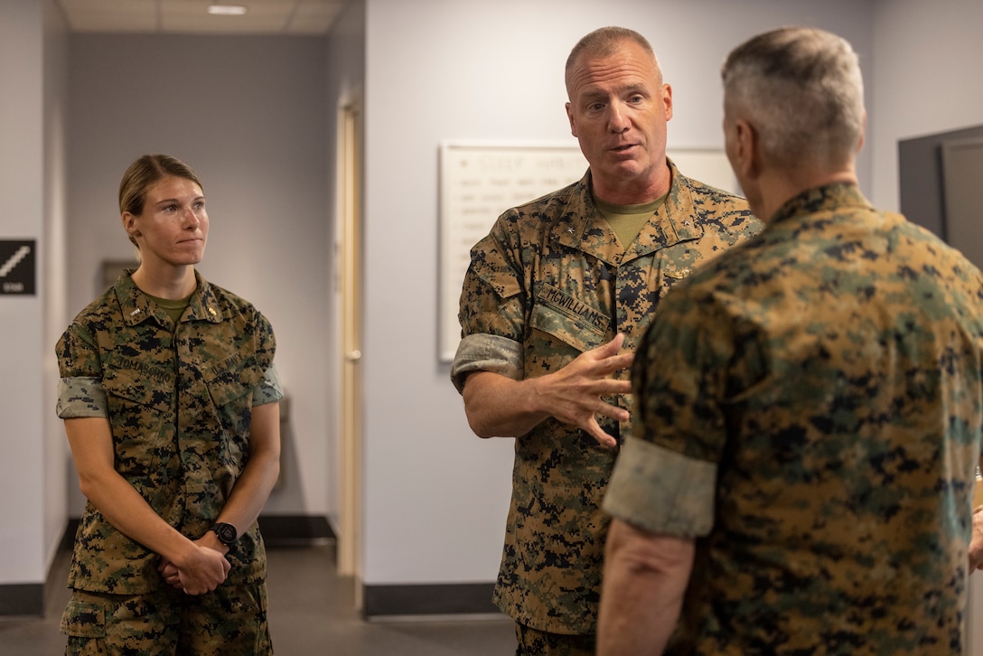 U.S. Marine Corps Brig. Gen. Michael E. McWilliams, commanding general, 2nd Marine Logistics Group, back right, and U.S. Navy Lt. j.g. Madalyn Tomaschko, director of the 2d MLG Human Performance Center, left, speak with General Christopher J. Mahoney, Assistant Commandant of the Marine Corps, during his visit to the 2nd MLG HPC on Camp Lejeune, North Carolina, May 14, 2024. Gen. Mahoney visited various facilities and infrastructures of 2nd MLG while visiting Camp Lejeune. (U.S. Marine Corps photo by Lance Cpl. Jessica J. Mazzamuto)