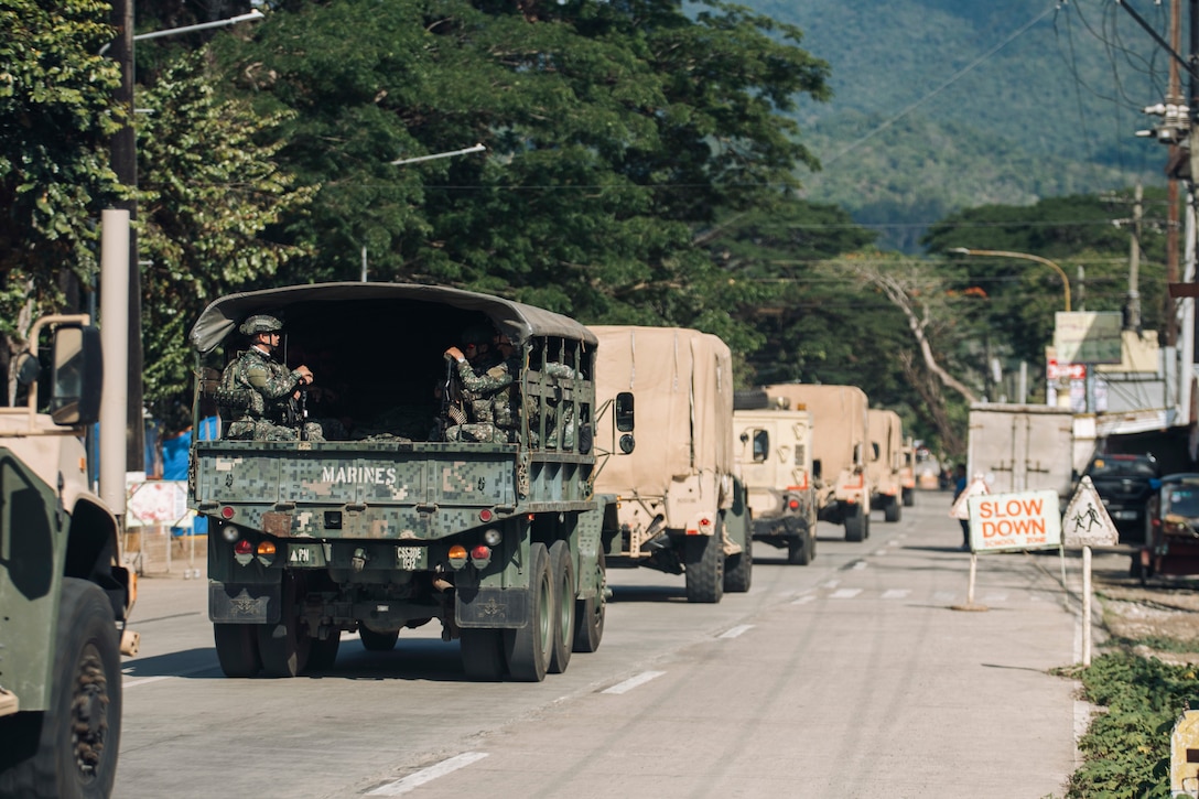 A Philippine Marine Corps KM250 truck attached to the 3rd Marine Brigade drives in a column with U.S. Marines assigned to the 15th Marine Expeditionary Unit through Palawan, Philippines, during a combined convoy and mobile defense exercise as part of Archipelagic Coastal Defense Continuum May 15, 2024. ACDC is a series of bilateral exchanges and training opportunities between U.S. Marines and Philippine Marines aimed at bolstering the Philippine Marine Corps' Coastal Defense strategy while supporting the modernization efforts of the Armed Forces of the Philippines. (U.S. Marine Corps photo by Cpl. Joseph Helms)