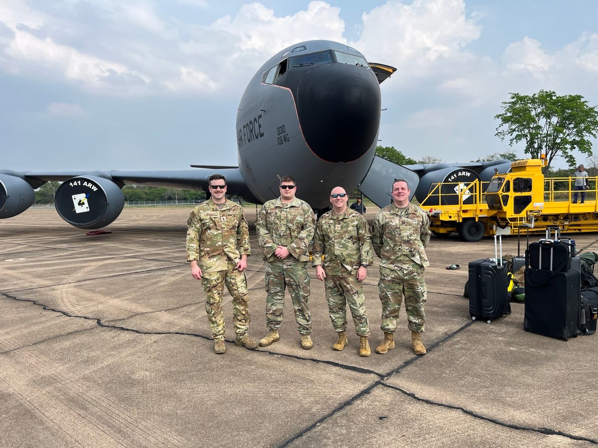 Airmen standing in from of a KC-135 Stratotanker
