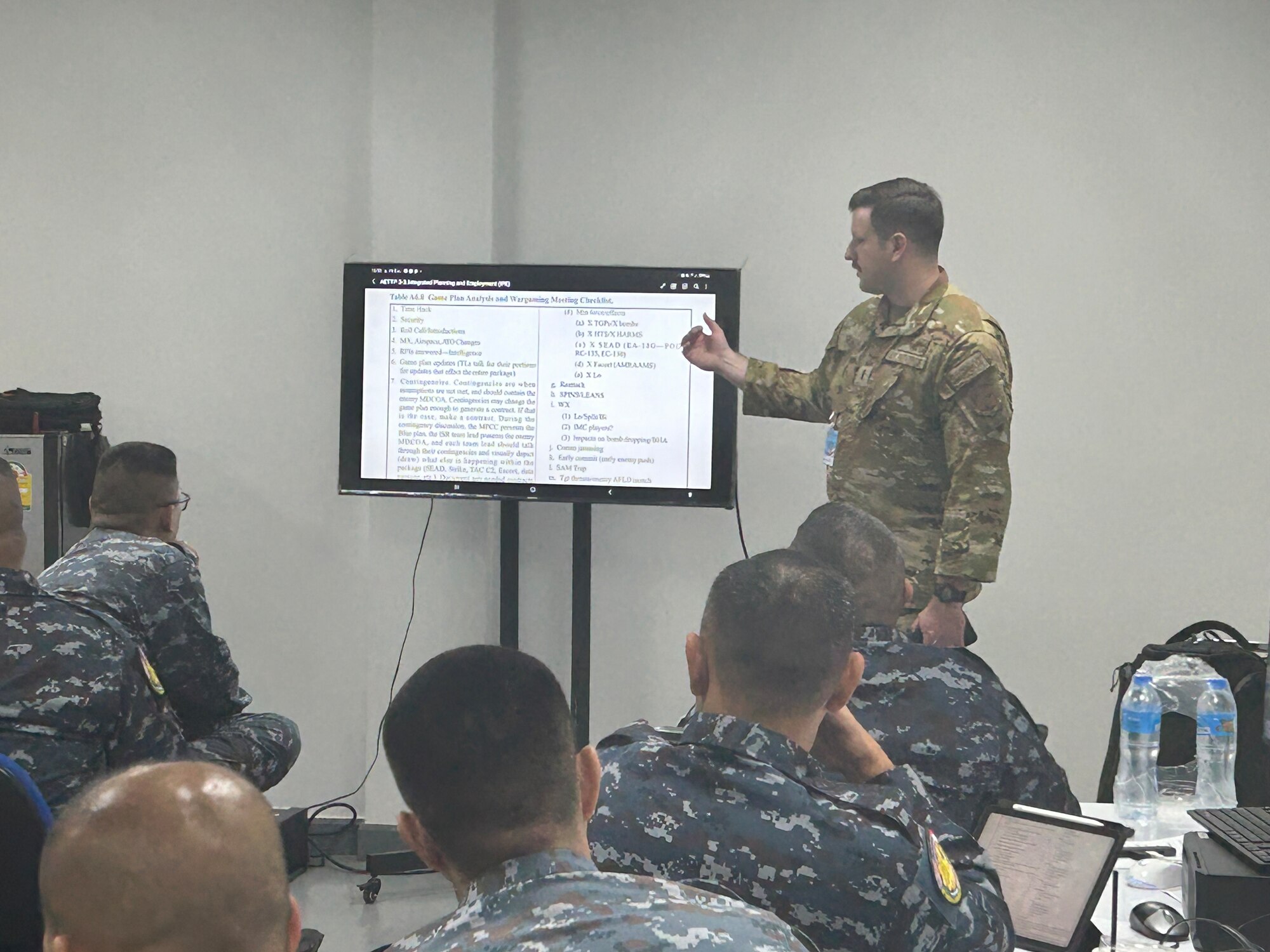 Airman pointing at computer screen