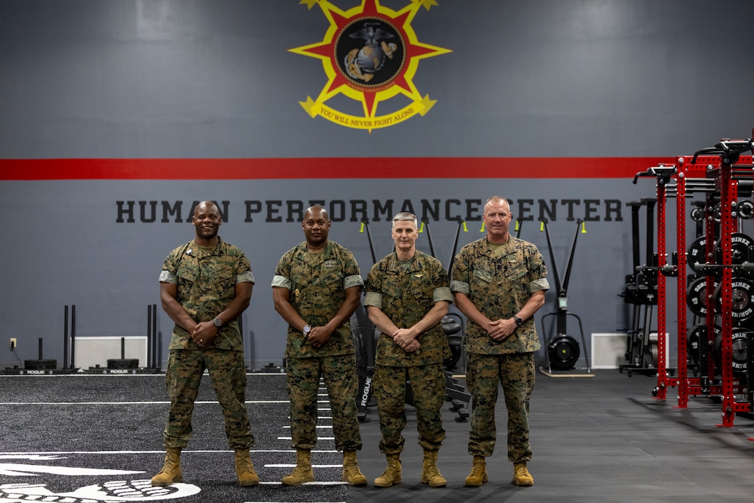 U.S. Marine Corps Brig. Gen. Michael E. McWilliams, commanding general, 2nd Marine Logistics Group, right, General Christopher J. Mahoney, Assistant Commandant of the Marine Corps, center right, U.S. Navy Master Chief  Joseph L. Johnson, command master chief, 2nd MLG, center left, and Sgt.Maj. Wesley Turner II, sergeant major of 2nd MLG, pose for a photo in the 2nd MLG Human Performance Center on Camp Lejeune, North Carolina, May 14, 2024. Gen. Mahoney visited various facilities and infrastructures of 2nd MLG while visiting Camp Lejeune. (U.S. Marine Corps photo by Lance Cpl. Jessica J. Mazzamuto)