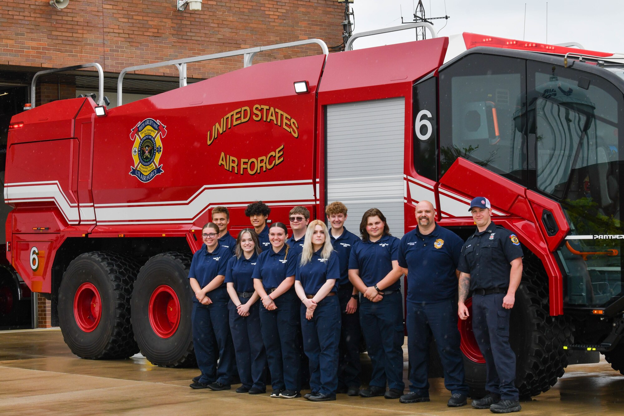Students from Barberton High School and firefighters assigned to the 910th Airlift Wing pose for a group photo in front of fire engine 6 at Youngstown Air Reserve Station, Ohio, May 17, 2024.