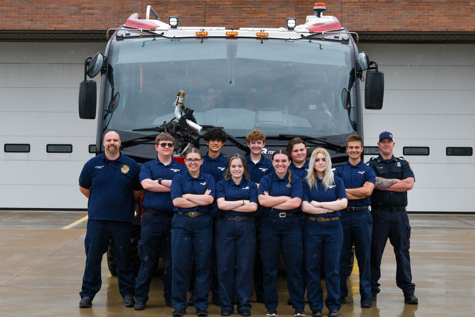 Students from Barberton High School and firefighters assigned to the 910th Airlift Wing pose for a group photo in front of fire engine 6 at Youngstown Air Reserve Station, Ohio, May 17, 2024.