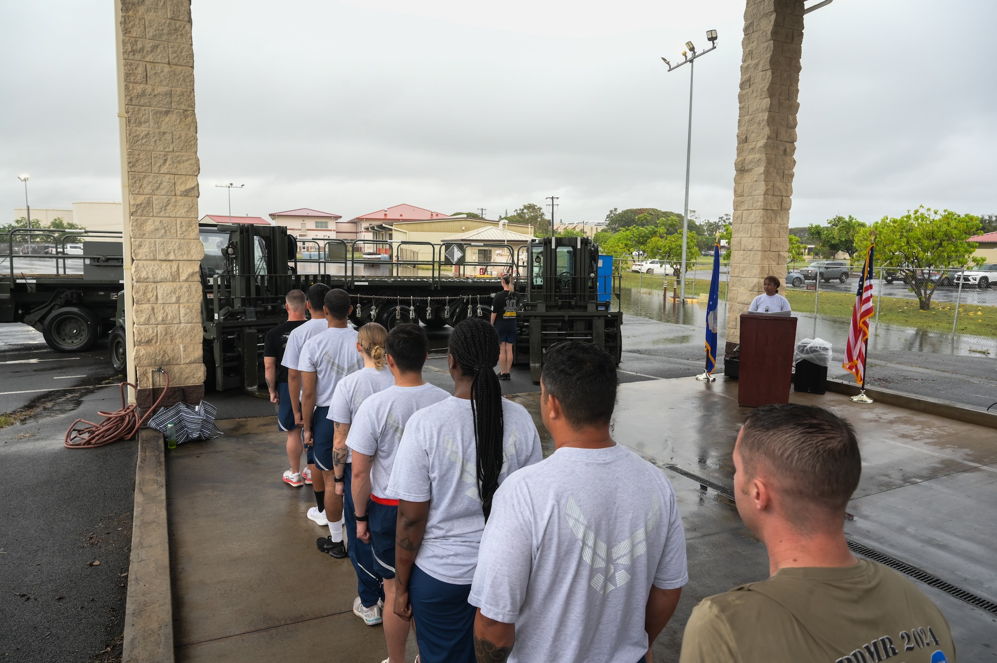 Airmen stand in formation in the rain.