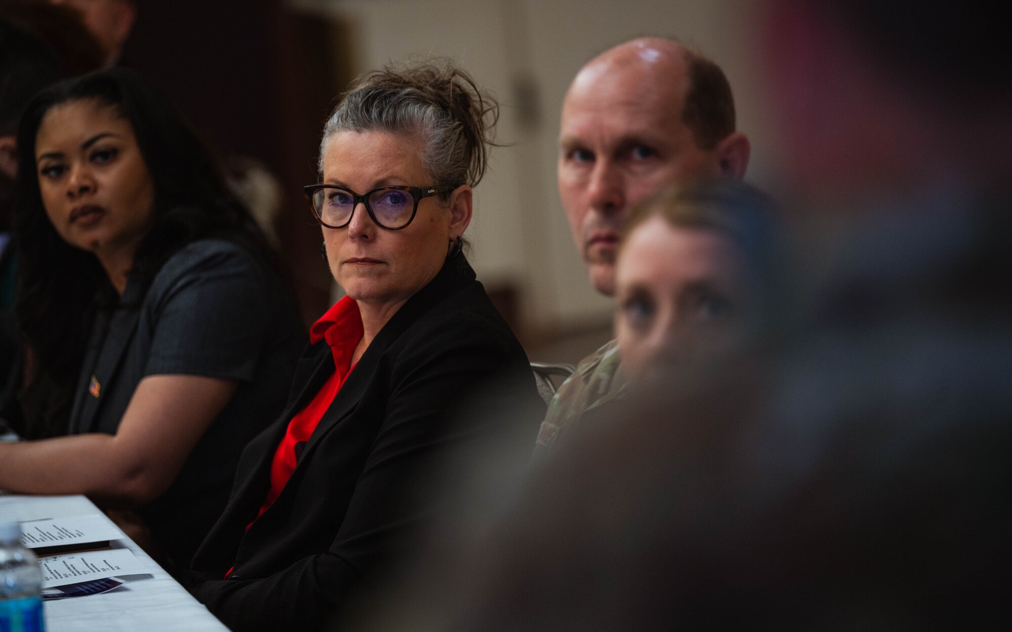 Arizona Governor Katie Hobbs looks to U.S. Air Force Col. Peter Abercrombie, 56th Mission Support Squadron commander, at a roundtable discussion about the Military Interstate Children’s Compact Commission (MIC3) and the Purple Star School Program.