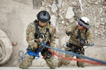 U.S. Air Force Tech Sgt. Frankie Bolaños, left, lowers himself on the line to simulate the rescue of Tech Sgt. Daniel Kolk, both fire contingency instructors with the Pacific Air Force, while demonstrating high-angle rescue techniques during the Field Training Exercise at Gobi Wolf 2024 in Choibalsan, Mongolia, May 9. The teams showcased best practices in safely extracting trapped individuals from precarious situations. Gobi Wolf 24 is part of the Pacific Resilience Disaster Response Exercise and Exchange program, which focuses on interagency coordination and foreign humanitarian assistance and is coordinated by the Mongolian National Emergency Management Agency and U.S. Army Pacific. (U.S. Army photo by Capt. Balinda O’Neal)