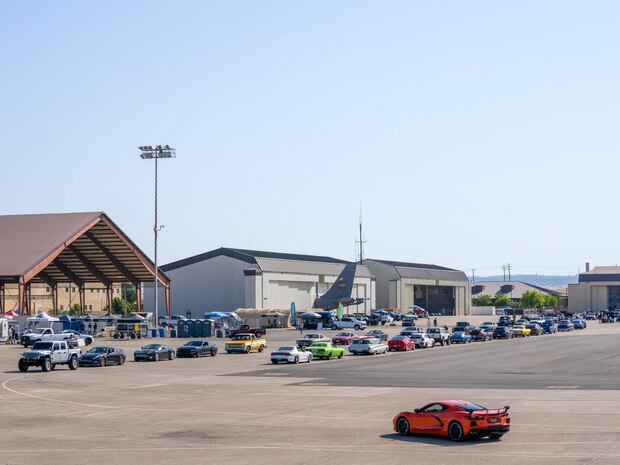 Two lines of vehicles form as some wait to get their photo taken in front of the U-2 Dragon Lady, while others return from the aircraft and wait for directions on where to display their vehicles May 18, 2024, at Beale Air Force Base, California.