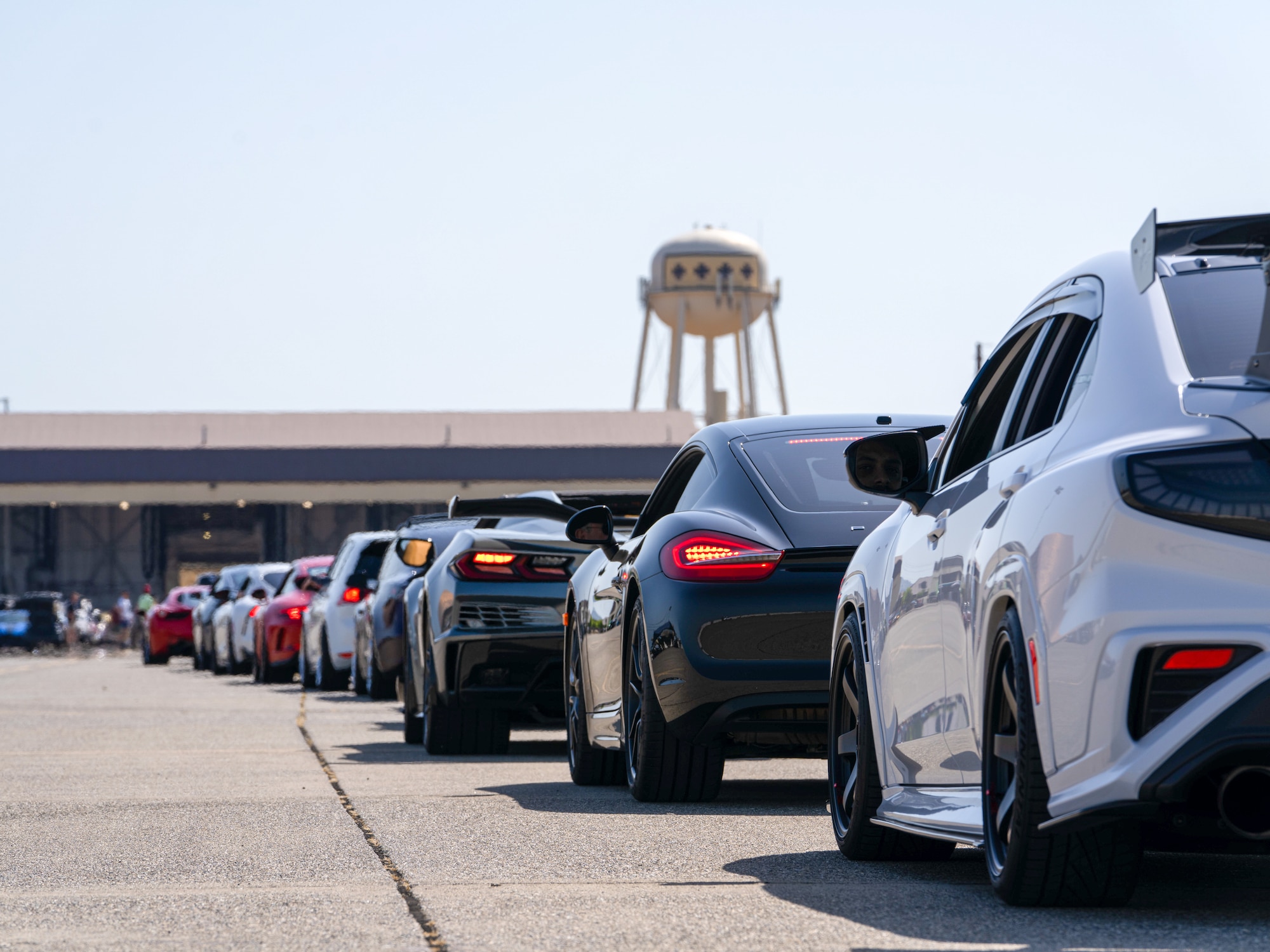 A line of vehicles returning from having their photo taken alongside the U-2 Dragon Lady wait for directions on where to park during the Beale Auto Expo, May 18, 2024, at Beale Air Force Base, California.