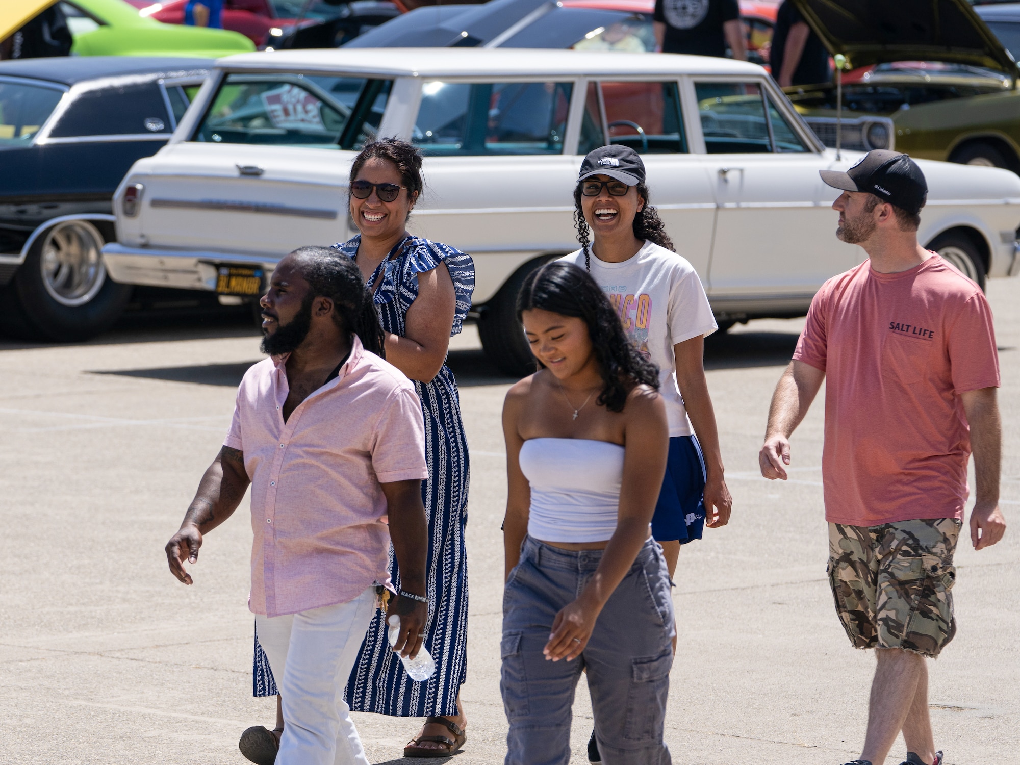 A group of visitors smile as they explore the Beale Auto Expo May 18, 2024, at Beale Air Force Base, California.