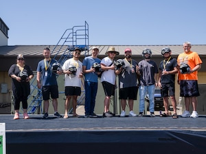 The winners from several categories pose with their trophy helmets during the Beale Auto Expo, May 18, 2024, at Beale Air Force Base, California.