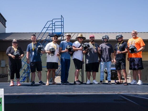 The winners from several categories pose with their trophy helmets during the Beale Auto Expo, May 18, 2024, at Beale Air Force Base, California.