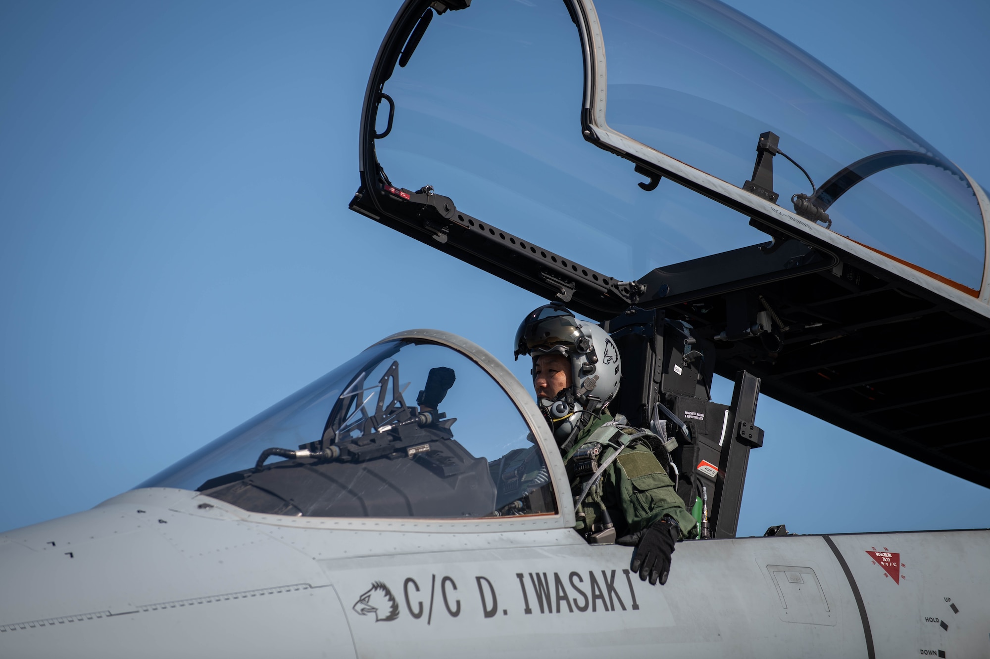 A JASDF pilot signals ground crew.