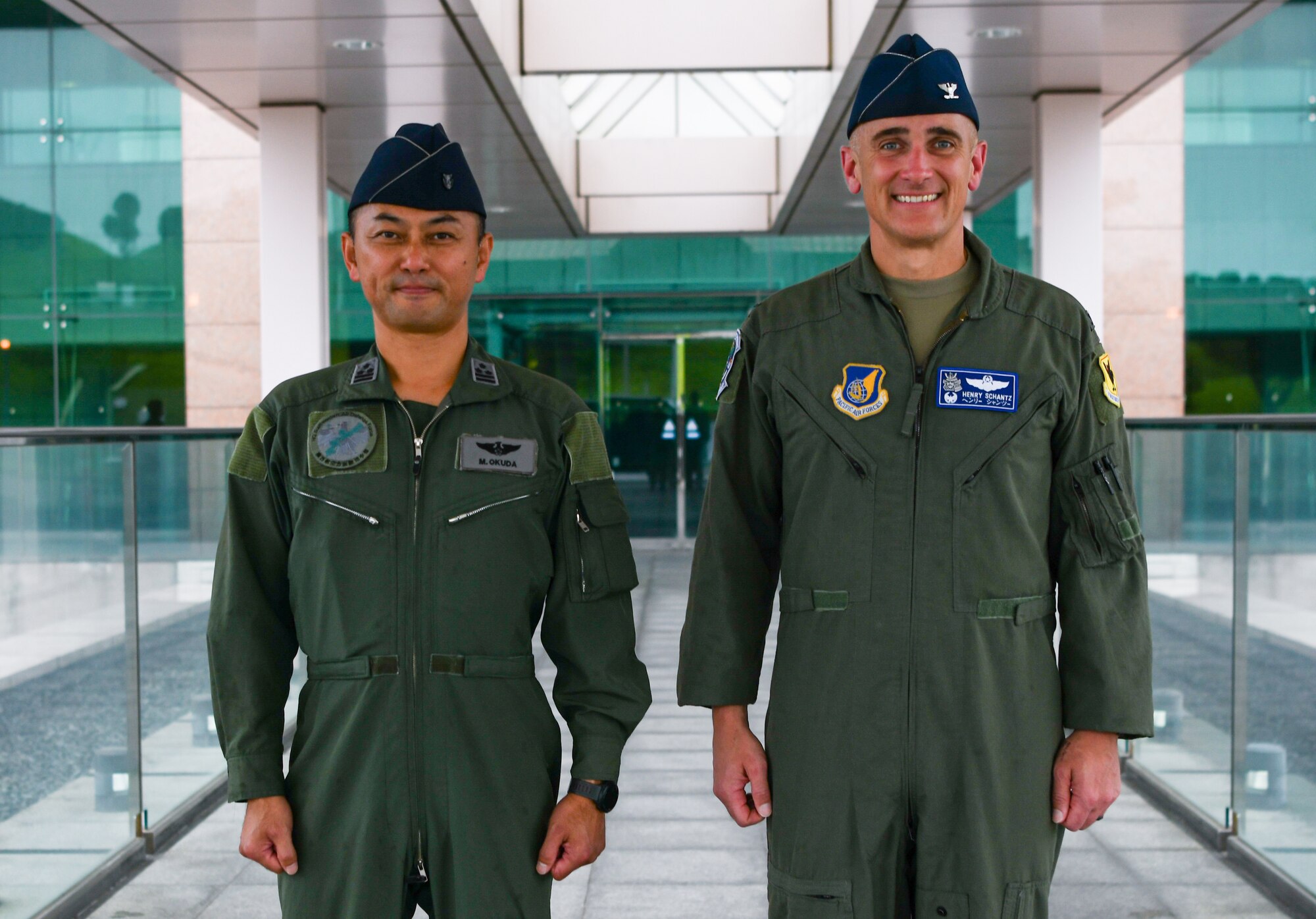 the 18th Operations Group commander and the Southwestern Air Defense Force defense plans and operations commander pose for a photo.