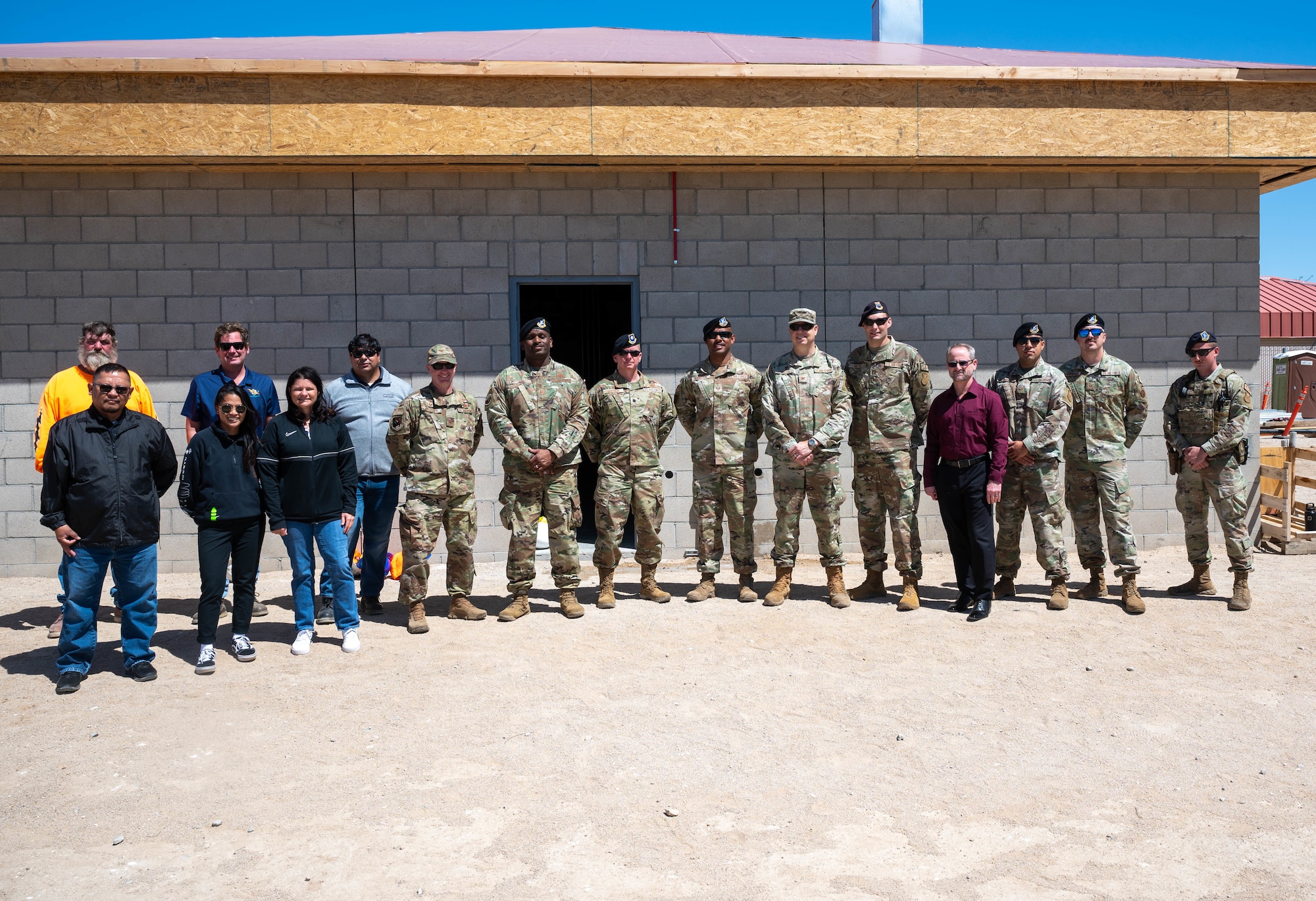 Team Edwards members from the 412th Civil Engineer Group and 412th Security Forces Squadron pose for a photo in front of the new military working dog facility, which is set to officially open July 31. (Air Force photo by Harley Huntington)
