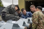 U.S. Air Force, Royal Australian Air Force, and Japan Air Self-Defense Force members construct munitions during a Combat Ammunition Production Exercise (CAPEX) at Misawa Air Base, Japan, May 8, 2024. This iteration of CAPEX was the first iteration held at Misawa Air Base since 1993 and the first iteration ever to be conducted alongside two partner nations in support of the Department of the Air Force’s modernization for Great Power Competition. (U.S. Air Force photo by Airman 1st Class Patrick Boyle)