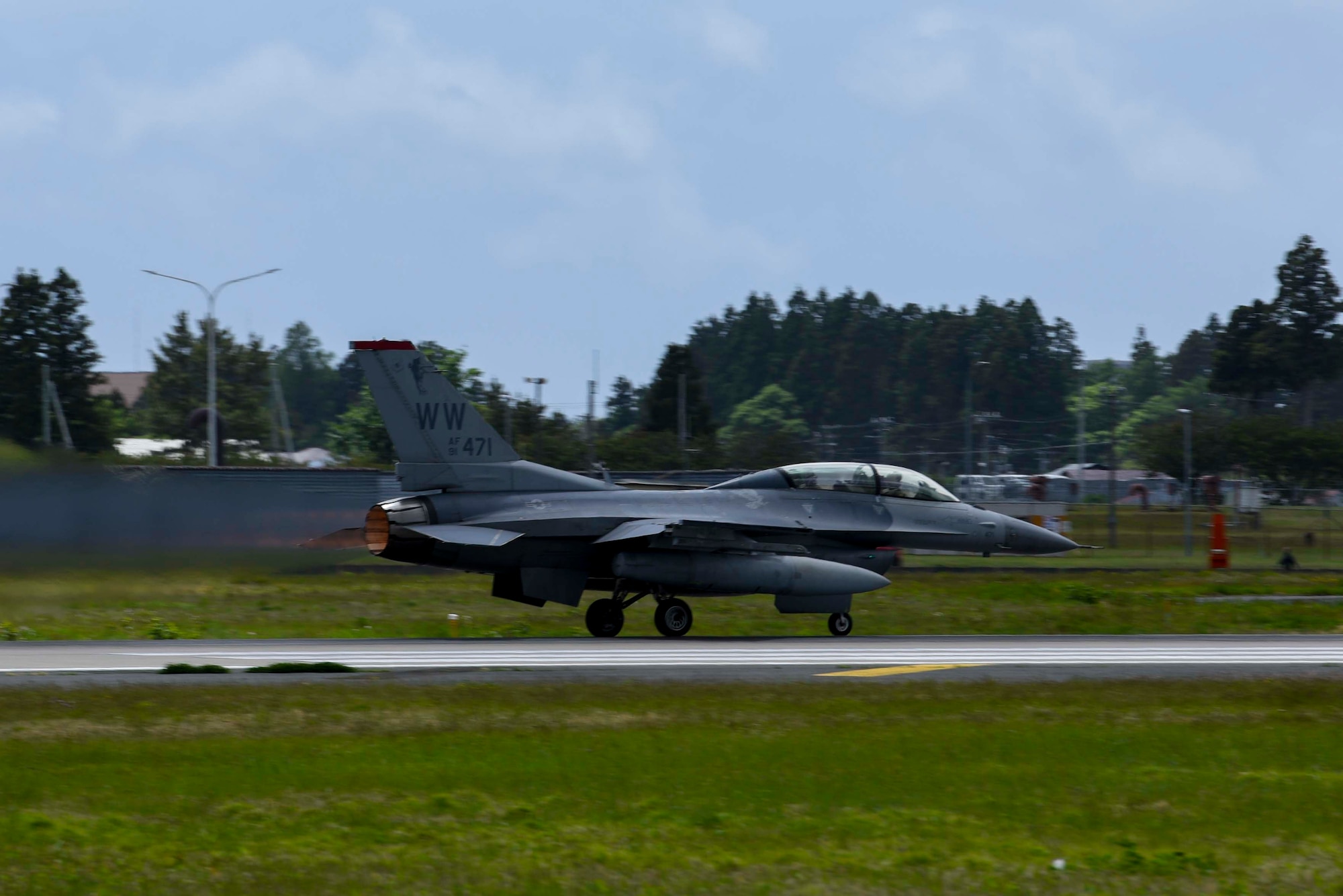 A U.S. Air Force F-16 Fighting Falcon with Col. Michael Richard, 35th Fighter Wing commander, and Mr. Yoshinori Kohiyama, Misawa City mayor, perform a high-speed taxi down the runway at Misawa Air Base, Japan, May 17, 2024. This demonstration showcased the power and agility of the F-16 Fighting Falcon. The event was part of the 'Wing Commander for a Day' program, which aims to enhance community relations and provide local leaders with an in-depth understanding of the 35th Fighter Wing's operational capabilities and commitment to regional security. (U.S. Air Force photo by Staff Sgt. Kristen Heller)
