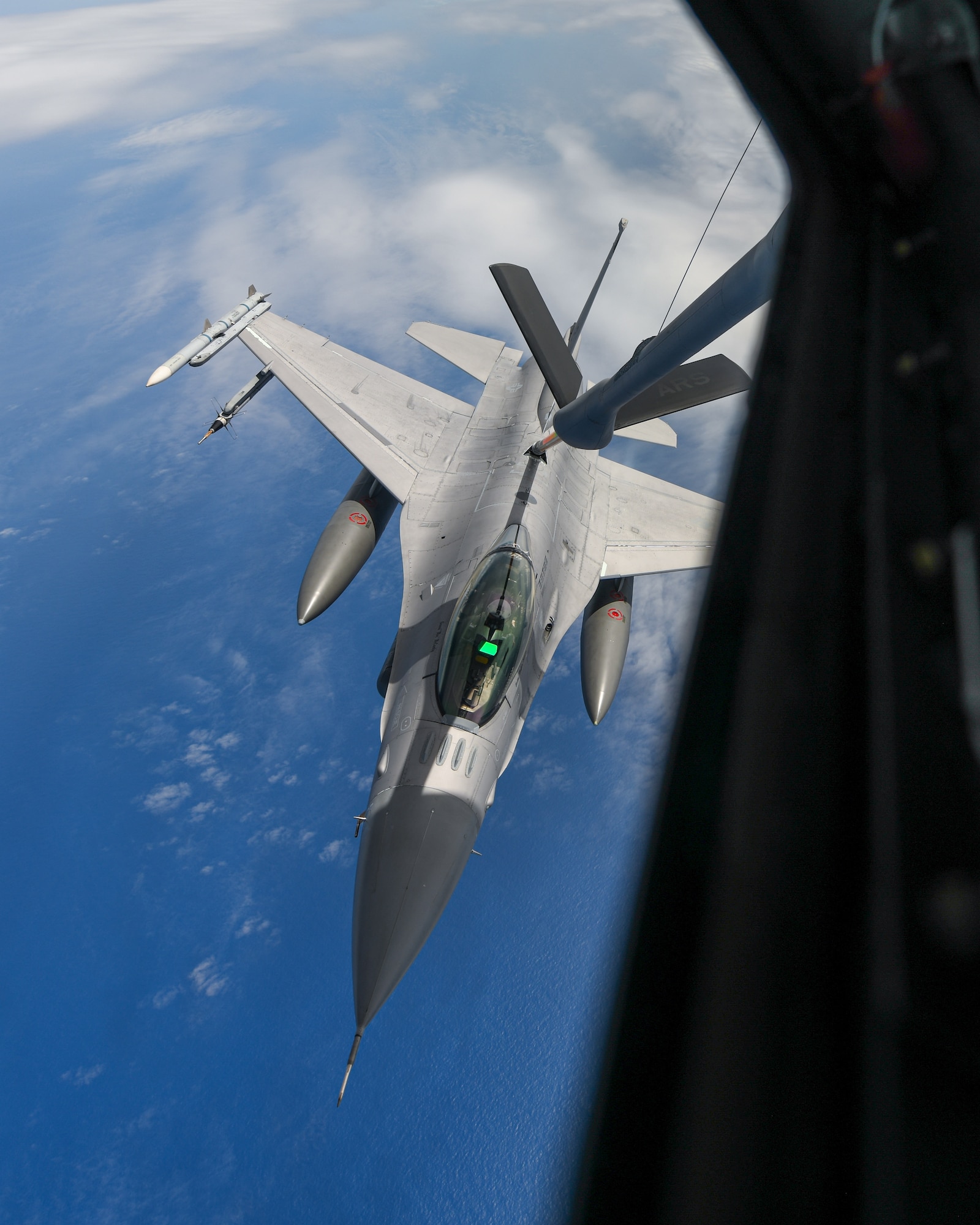 An F-16 conducts aerial refueling.