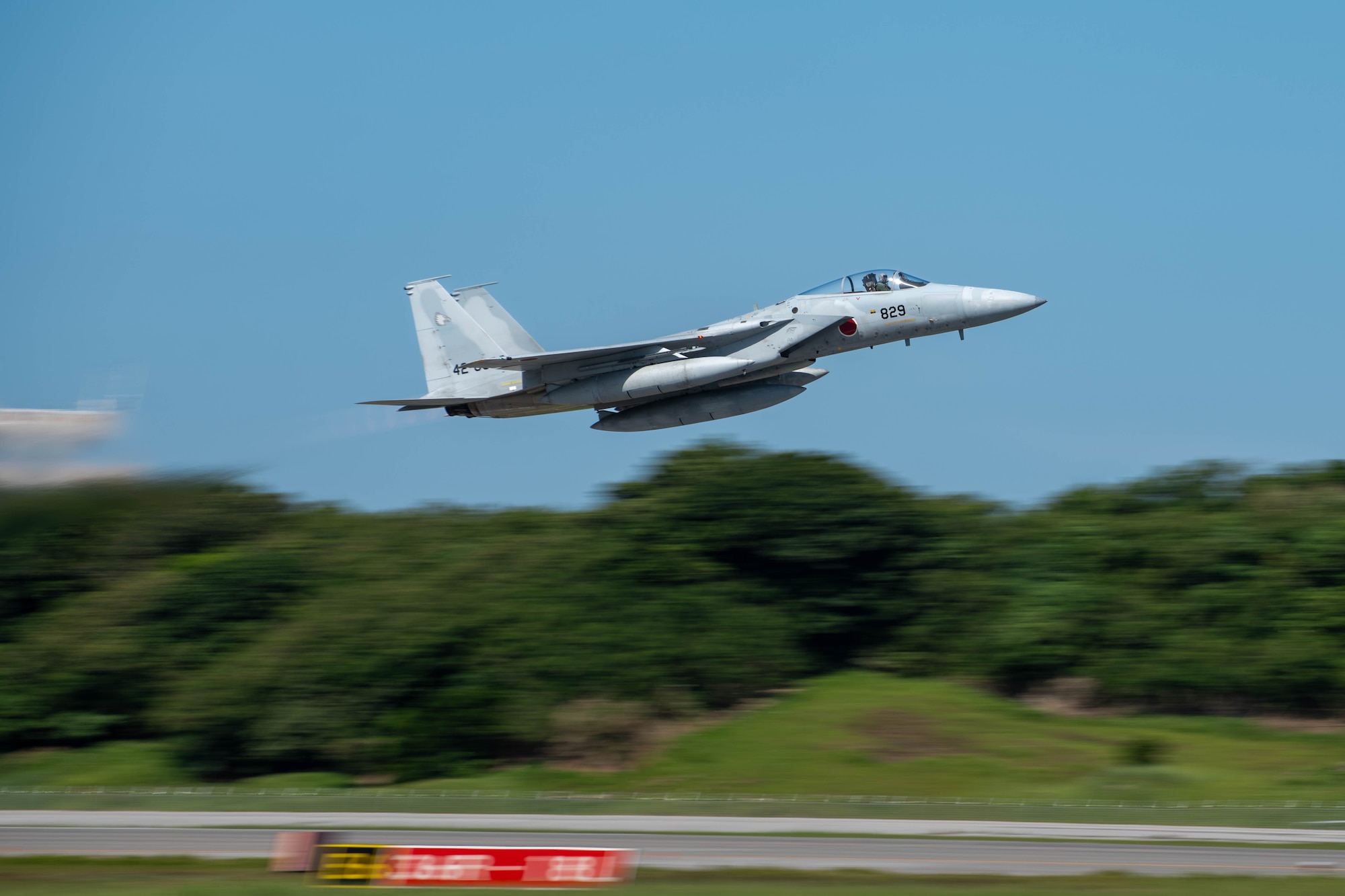 A JASDF F-15J Eagle departs on a runway.