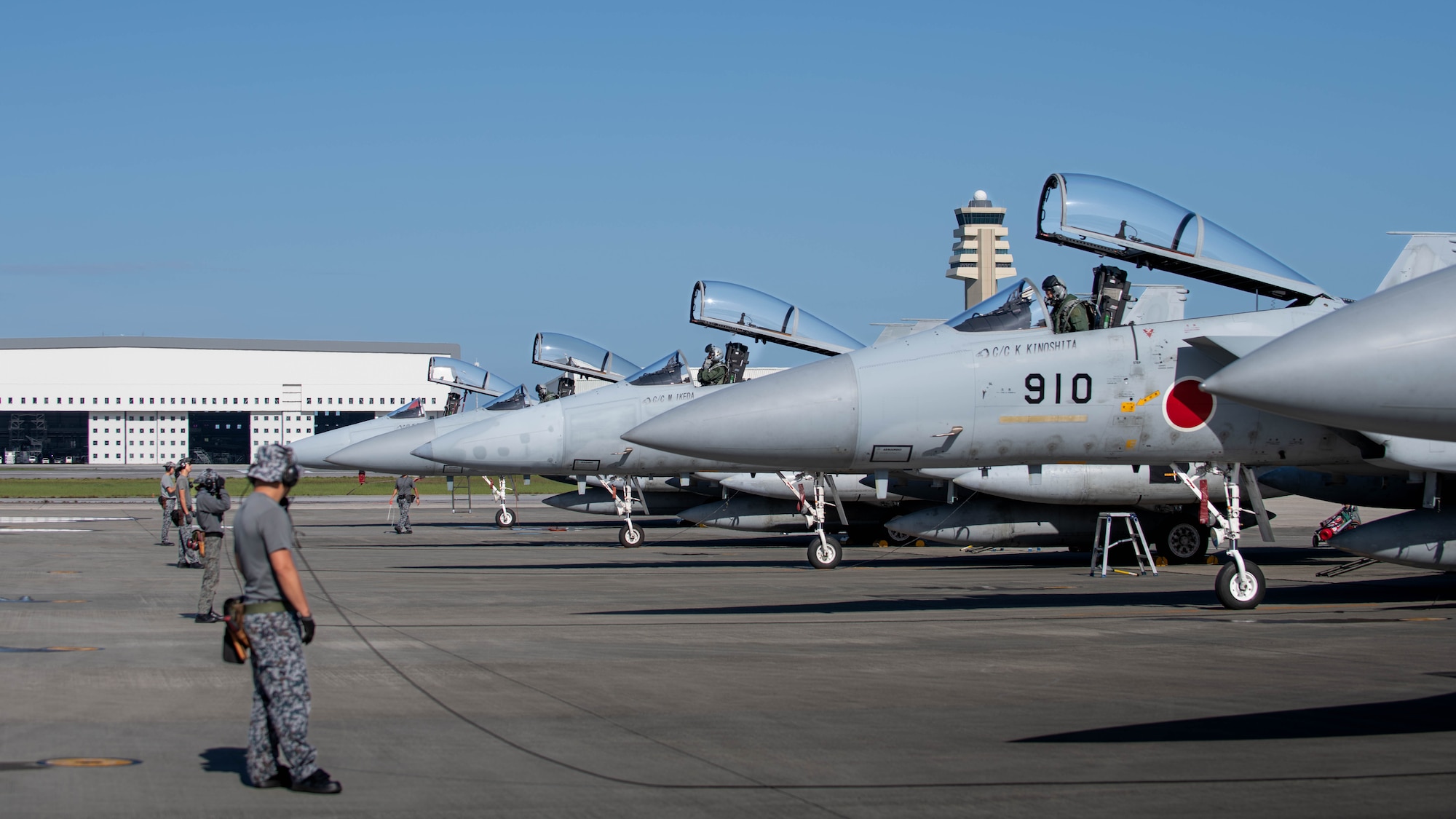 JASDF service members conduct pre-flight inspections.