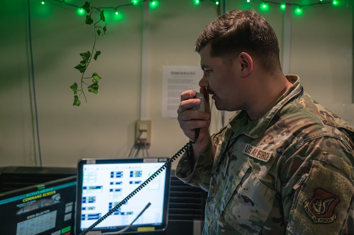 Staff Sgt. Brandon Fletcher, 8th Command Post non-commissioned officer in charge of systems, activates the giant voice at Kunsan Air Base, Republic of Korea