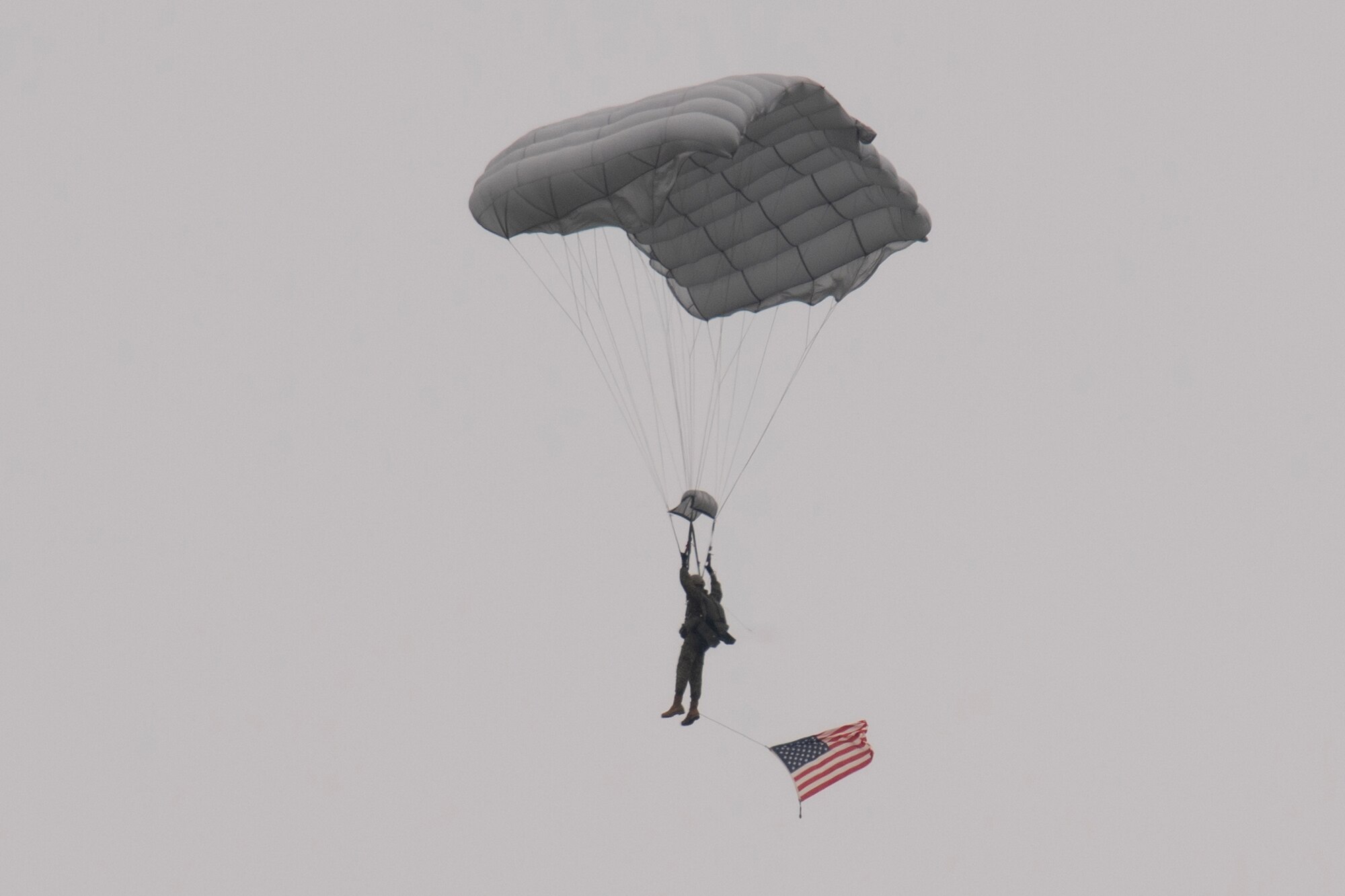 A Japan Ground Self-Defense paratrooper assigned to the 1st Airborne brigade descends after jumping from a U.S. Air Force C-130J Super Hercules assigned to the 36th Airlift Squadron during the Japanese-American Friendship Festival 2024 at Yokota Air Base.