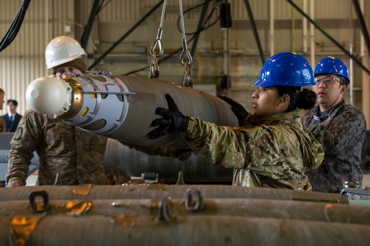 U.S. Air Force and Japan Air Self-Defense Force (JASDF) members carefully move munitions during a Combat Ammunition Production Exercise (CAPEX) at Misawa Air Base, Japan, May 8, 2024.