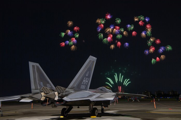 A U.S. Air Force F-22 Raptor assigned to the 199th Fighter Squadron sits on the flightline at Yokota Air Base, Japan, May 19, 2024 during the Japanese-American Friendship Festival fireworks display.