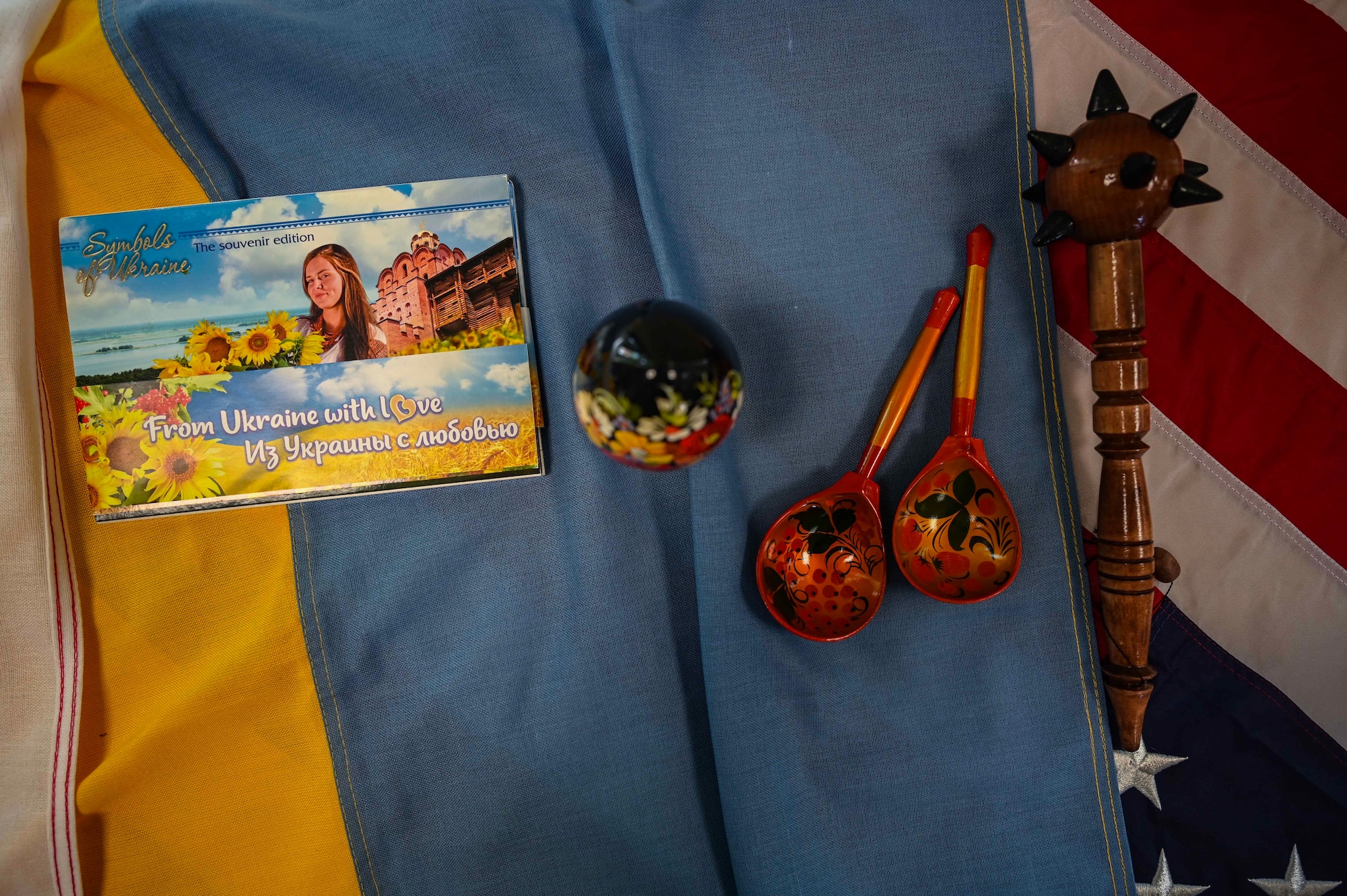 Ukrainian souvenirs are displayed on Ukrainian and American flags symbolizing the unity of two nations during a Language Enabled Airmen Postured for Agile Combat Employment training at Royal Air Force Mildenhall, England, May 6, 2024.