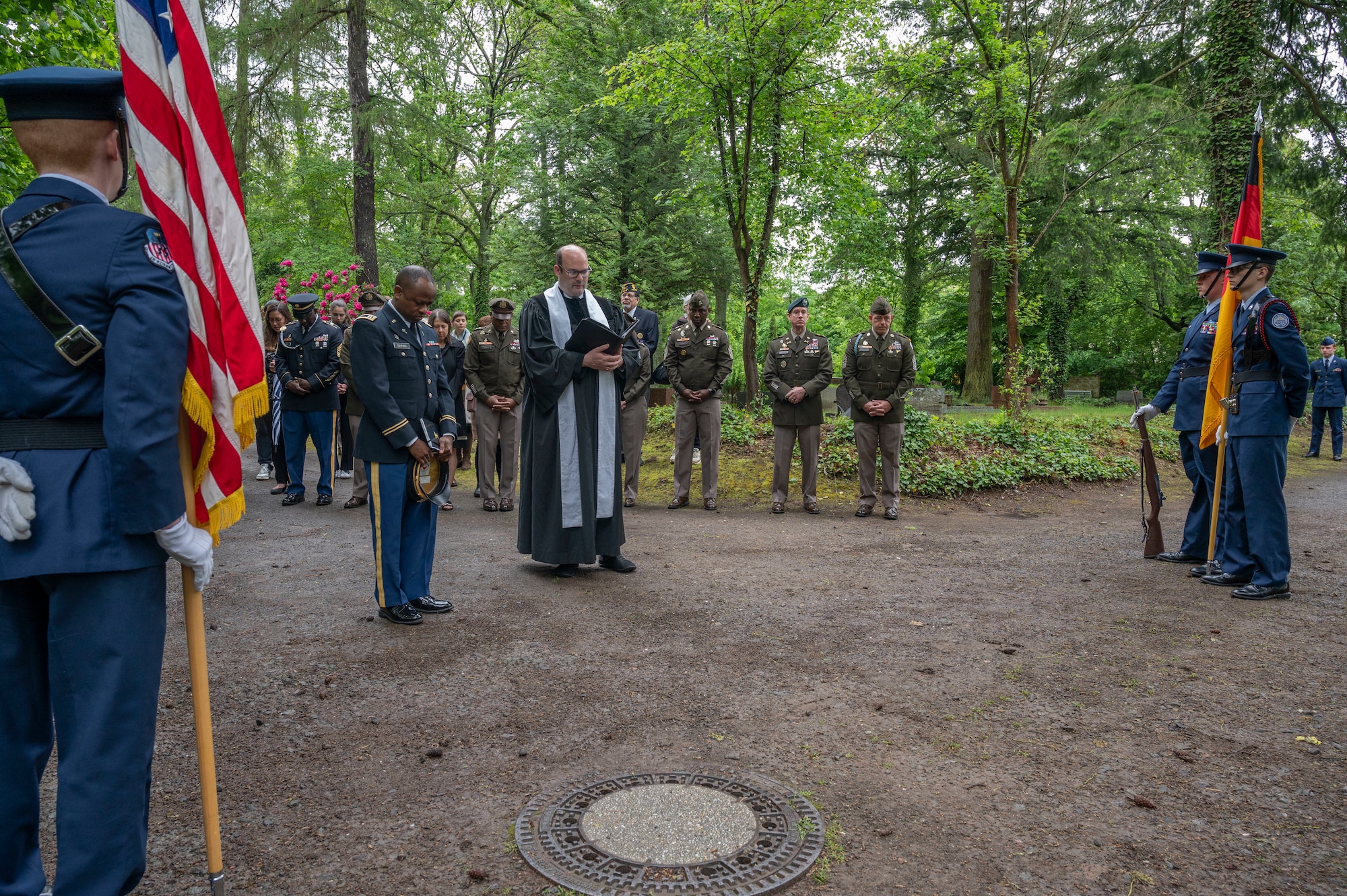 Two chaplains pray over a gravesite