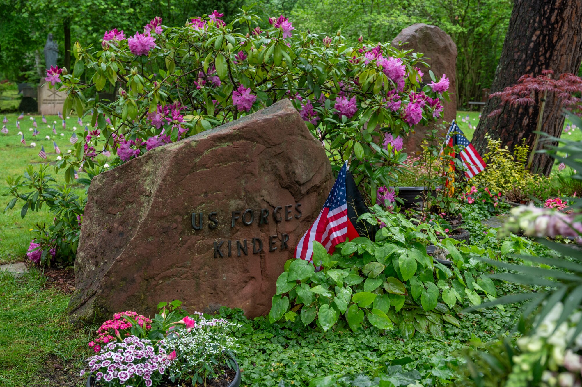 A rock with words is next to the Kindergraves to mark the graves