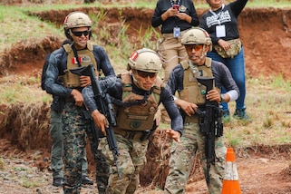 Peruvian Team competitors cheer on a teammate as he sprints to the firing line during the combined ranges of Fuerzas Comando 24 (FC24) Skills and Shooting Tests in Cerro Tigre, Panama, May 16, 2024.