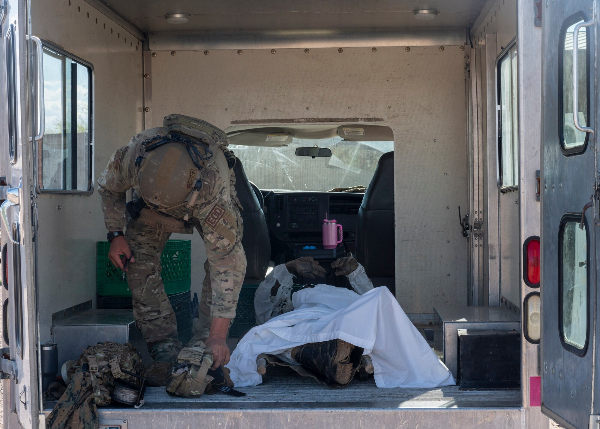 An Explosive Ordnance Disposal U.S. Airman assigned to the 355th Civil Engineering Squadron searches a simulated casualty for an improvised explosive device during the Mission Support
Group Phase II training exercise at Davis-Monthan Air Force Base, Ariz., May 13, 2024. EOD worked with 355th Force Support Squadron Airmen during this training exercise. (U.S. Air Force photo by Airman 1st Class William Finn V)