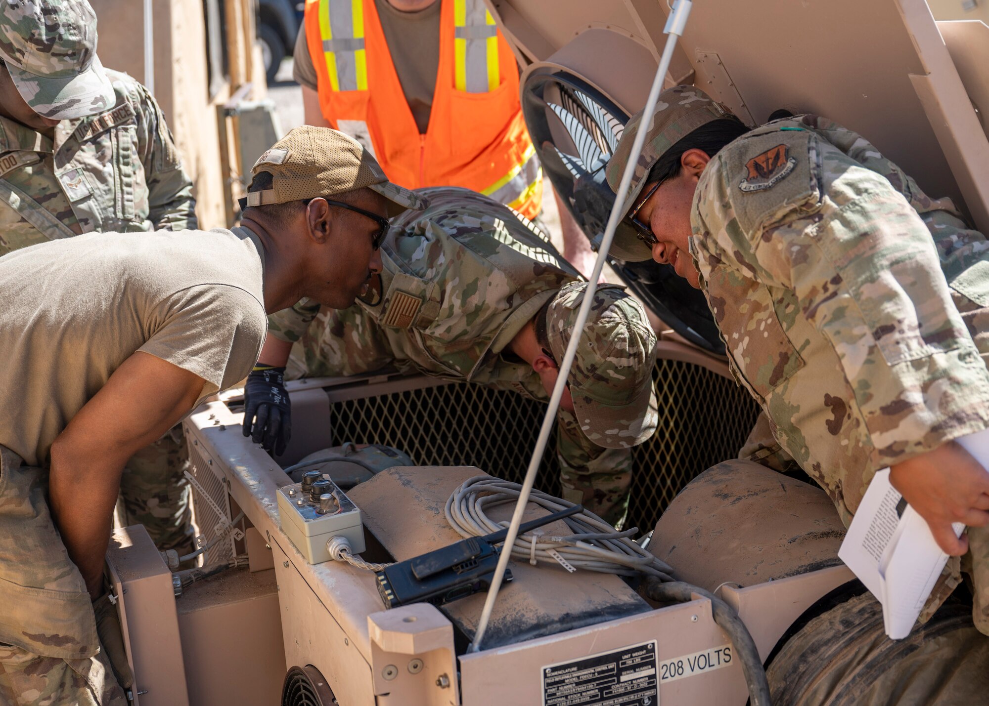 U.S. Airmen assigned to the 355th Civil Engineering Squadron work on an air conditioning unit during the Mission Support Group Phase II training exercise at Davis-Monthan Air Force Base, Ariz., May 13, 2024. The Phase II exercise included Airmen from several different career fields all participating in different readiness
exercises. (U.S. Air Force photo by Airman 1st Class William Finn V)