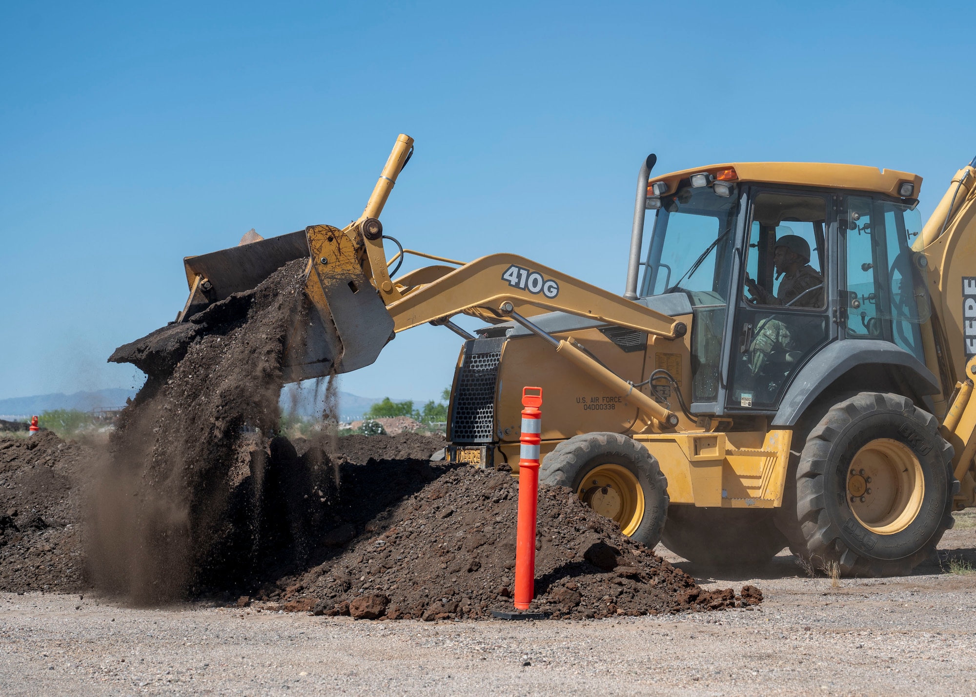 A U.S. Airman assigned to the 355th Civil Engineering Squadron builds a dirt berm during the Mission Support Group Phase II training exercise at Davis-Monthan Air Force Base, Ariz., May 13, 2024. The training focused on operations that would take place in a deployed environment. (U.S. Air Force photo by Airman 1st Class William Finn V)