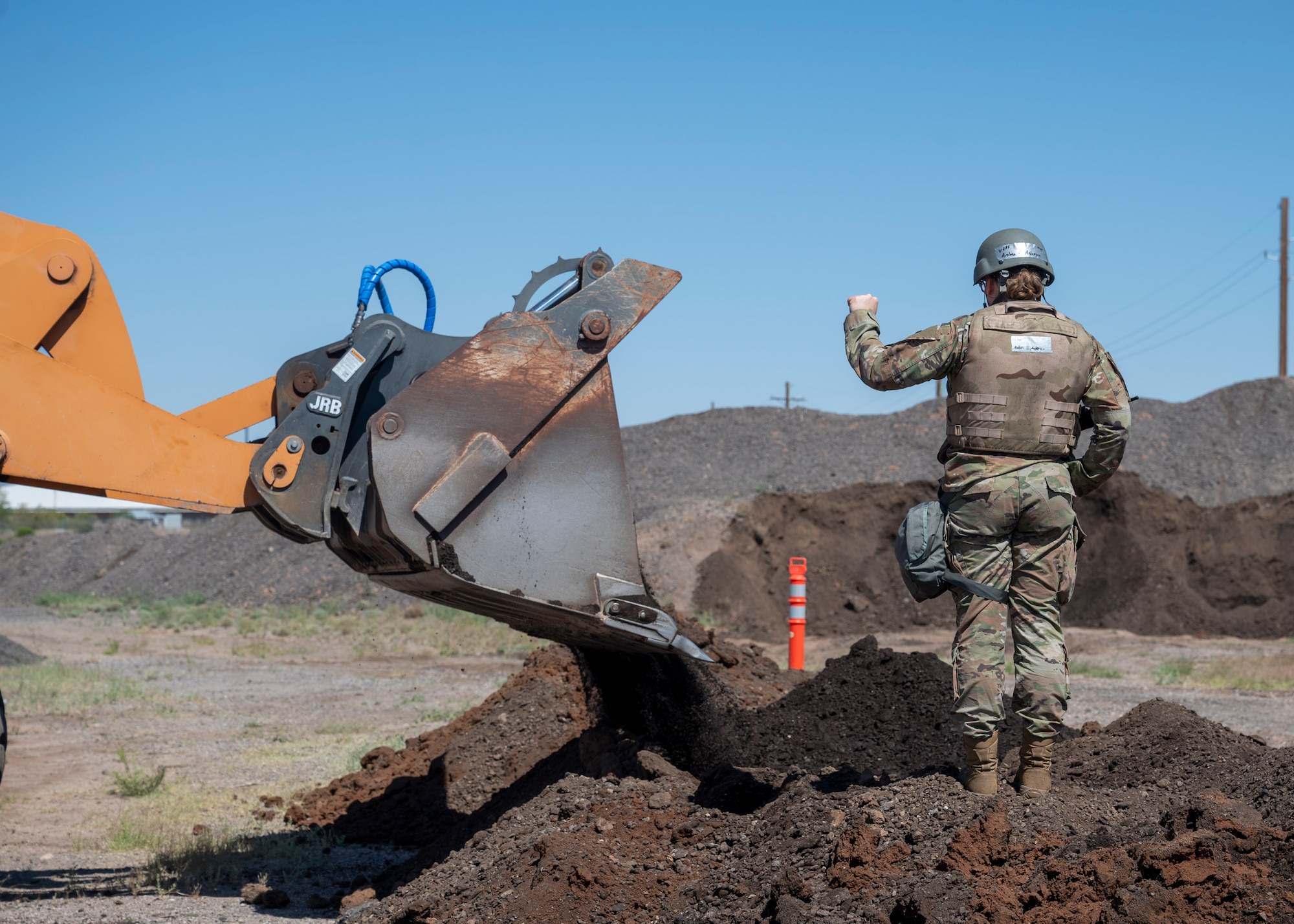 A U.S. Airman assigned to the 355th Civil Engineering Squadron directs the construction of a dirt berm during the Mission Support
Group Phase II training exercise at Davis-Monthan Air Force Base, Ariz., May 13, 2024. The MSG Phase II exercise focused on tasks Airmen would perform in a deployed environment. (U.S. Air Force photo by Airman 1st Class William Finn V)