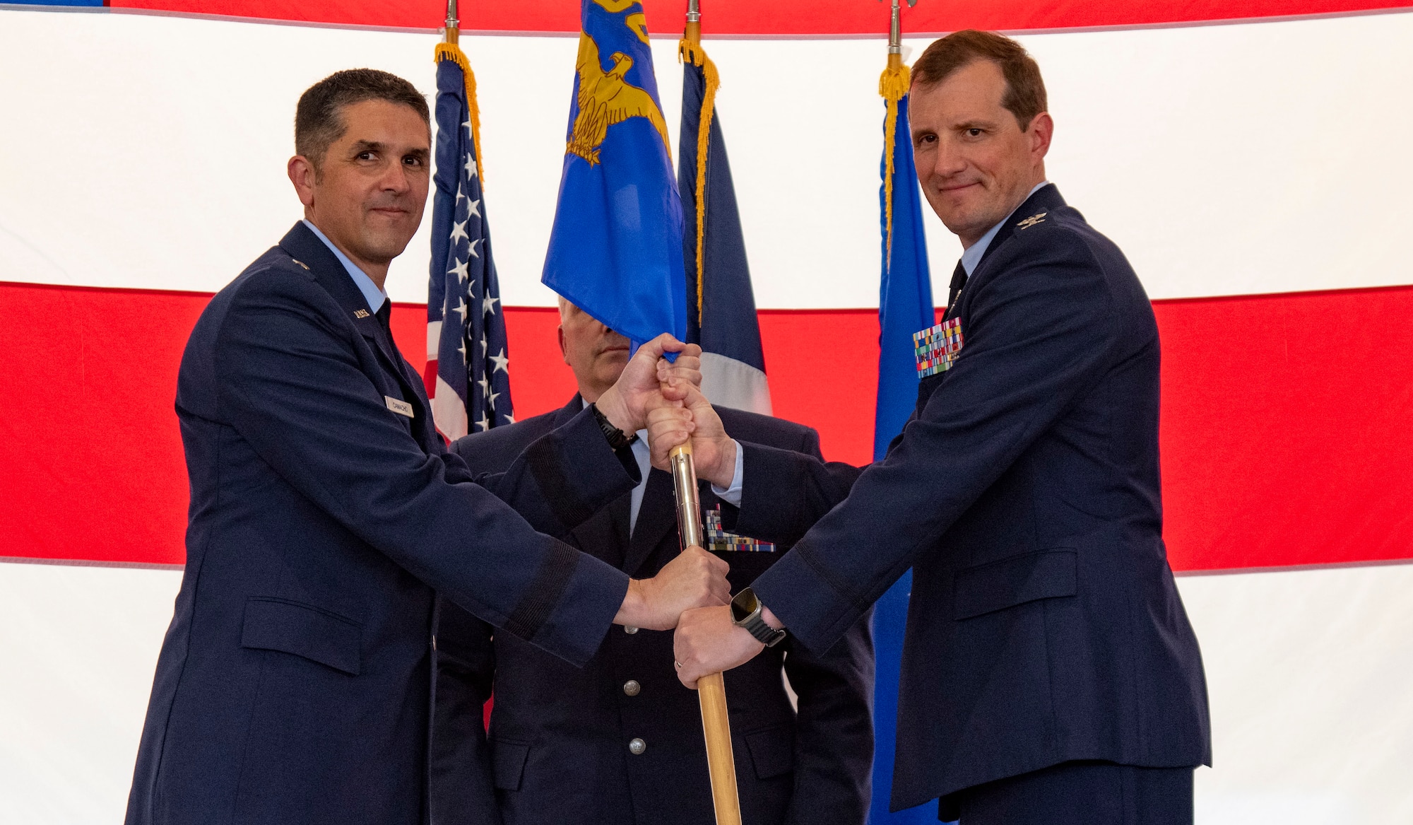 Two Air Force officers hold on to a guidon.