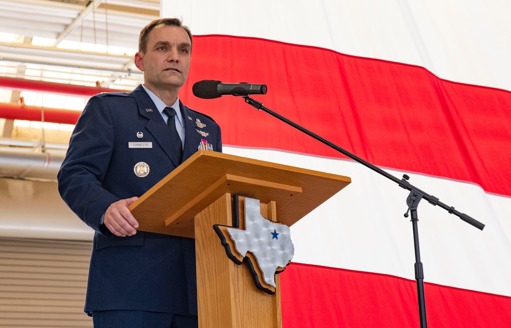 Air Force officer stands behind a podium.