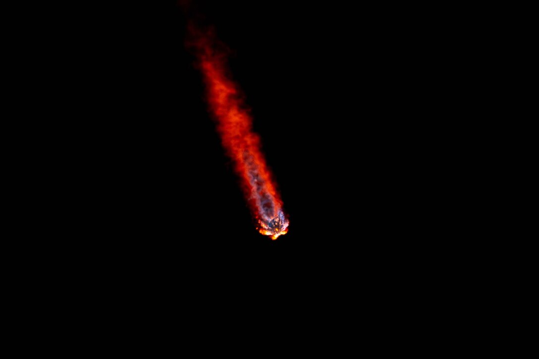A rocket flies across a darkened sky.
