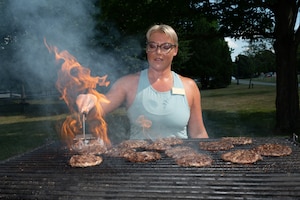image of woman cooking burgers