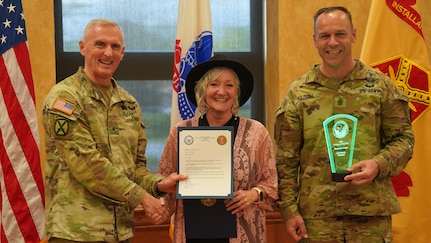 Kimberly Cooper, wife of U.S. Army Medical Materiel Agency Commander Col. Gary Cooper, was named one of Fort Detrick’s three Volunteers of the Year in a ceremony April 18. Cooper is pictured with Brig. Gen. Edward Bailey, left, commanding general of U.S. Army Medical Research and Development Command and Fort Detrick, and Command Sgt. Maj. Kyle Brunell. (U.S. Army photo by Samuel Mensah/USAMRDC)