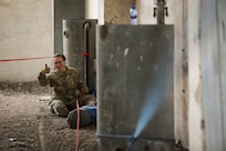 Airman 1st Class Stefany Brummer, a fire protection specialist with the Alaska Air National Guard, operates the backup safety line during the Field Training Exercise’s high-angle rescue techniques training at Gobi Wolf 2024 in Choibalsan, Mongolia, May 9. The teams showcased best practices in safely extracting trapped individuals from precarious situations.