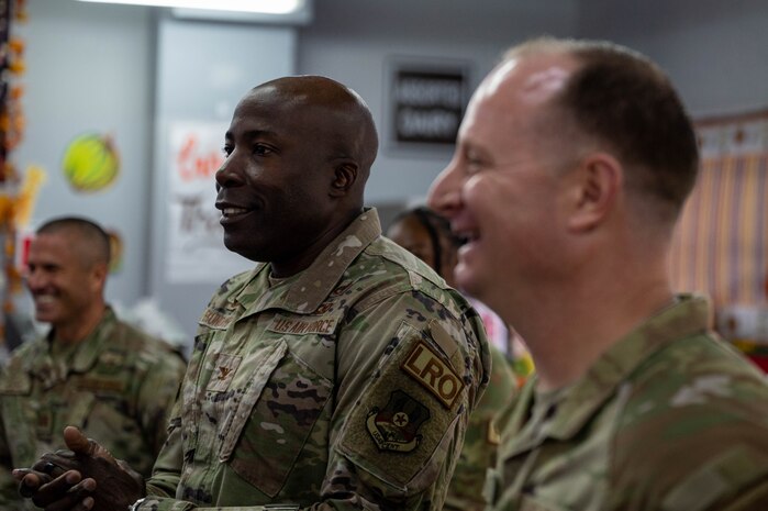Photo of Col. Ekundayo giving opening remarks before Thanksgiving meal.